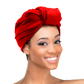 Woman wearing the Qfitt Doobie Cap With Silky Scarf, a hair wrap cap with an attached scarf.